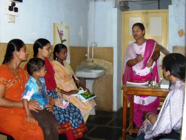 Educator conducting HIV/AIDS session for women and children