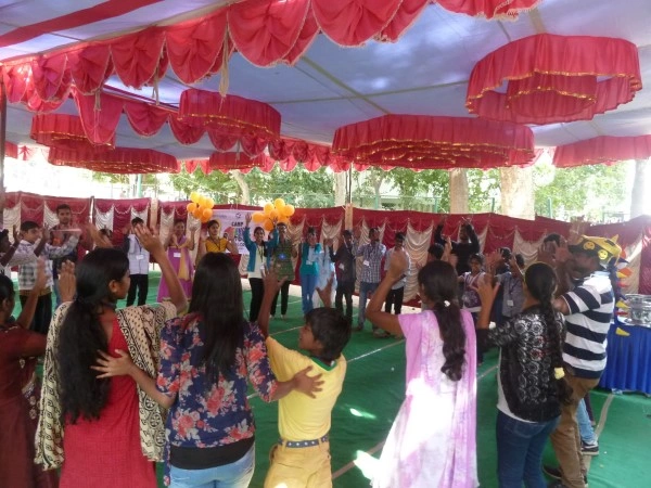 Outdoor group activity for HIV/AIDS awareness with children and women
